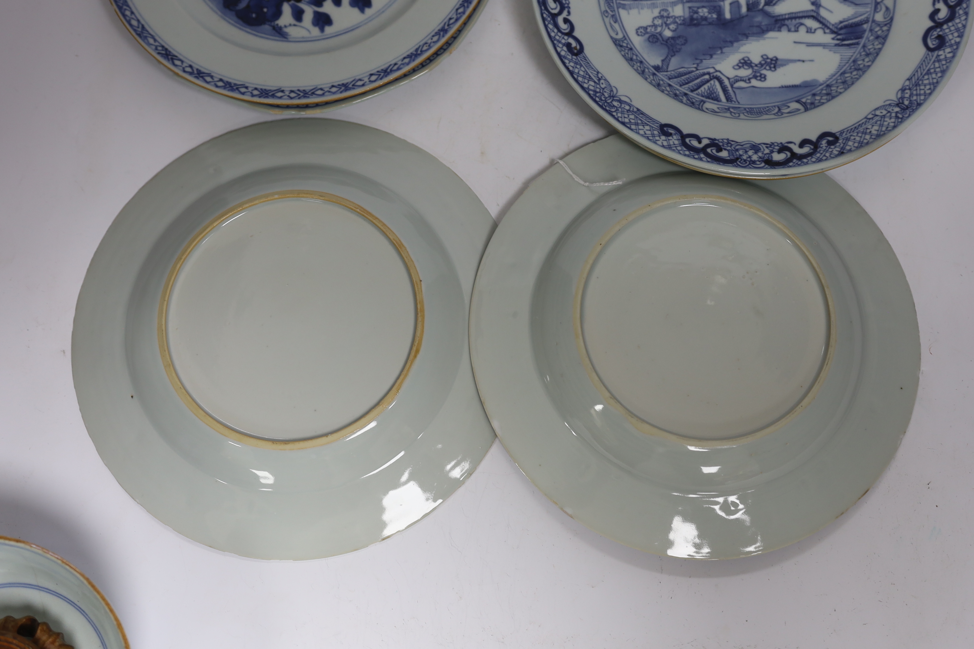 Six Chinese blue and white plates, 18th century and a Kangxi blue and white bowl and wood stand